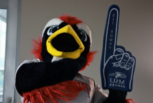 Rowdy the mascot with a pointer foam finger that says Get Rowdy